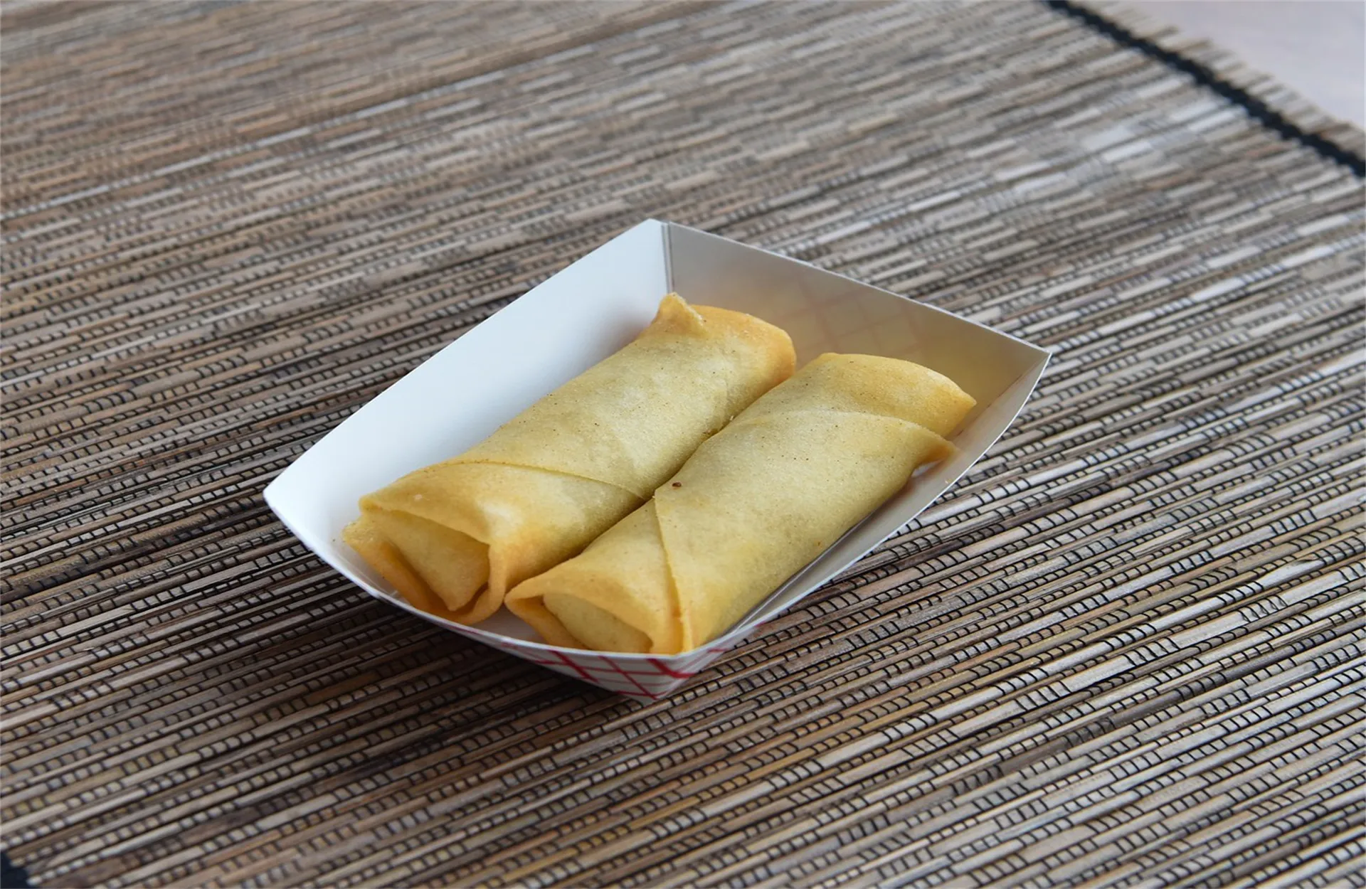 Two crispy fried spring rolls in paper tray at Mei Wei Chinese Restaurant, Chinese Restaurant in Modesto